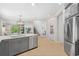 Open concept kitchen with a large center island, stainless steel appliances, and seamless flow to living areas at 5532 Summit Gln, Bradenton, FL 34203