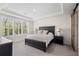 Serene main bedroom with a window view, tray ceiling, and stylish, modern furnishings at 5532 Summit Gln, Bradenton, FL 34203