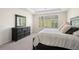 Relaxing main bedroom with a window view, dresser and plush bedding, creating a peaceful retreat at 5532 Summit Gln, Bradenton, FL 34203