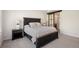 Comfortable main bedroom featuring a neutral palette, bedside lamps, and a barn door leading to the ensuite at 5532 Summit Gln, Bradenton, FL 34203