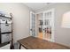 Cozy office space showcasing french doors leading into the kitchen and hardwood floors at 5532 Summit Gln, Bradenton, FL 34203