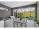 Screened outdoor kitchen and dining area next to the pool, perfect for entertaining and enjoying the view at 5532 Summit Gln, Bradenton, FL 34203
