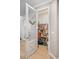 Organized walk-in pantry with wire shelving and decorative door with a wreath accent for added charm at 5532 Summit Gln, Bradenton, FL 34203
