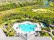 Overhead shot of a community pool area with surrounding lounge chairs and beautiful landscaping at 5740 Eagle Creek Rd, Sarasota, FL 34238