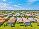 An aerial image of homes with pools overlooking a central lake, in a well-maintained community with green spaces at 5740 Eagle Creek Rd, Sarasota, FL 34238