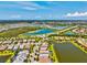 Expansive aerial shot of a community with lakes and roadways amid lush greenery, offering a serene residential environment at 5740 Eagle Creek Rd, Sarasota, FL 34238