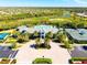 Aerial view of a community center with a pool, tennis courts, and lush landscaping at 5740 Eagle Creek Rd, Sarasota, FL 34238