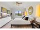 Bedroom with a ceiling fan, light wood floors, art, and a water view at 5740 Eagle Creek Rd, Sarasota, FL 34238