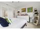 Bedroom with light wood floors, modern art and decor, and a view into the bathroom at 5740 Eagle Creek Rd, Sarasota, FL 34238