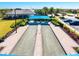 Aerial view of bocce ball courts with covered seating in a beautiful community setting and manicured landscaping at 5740 Eagle Creek Rd, Sarasota, FL 34238