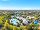 Aerial shot of community with pool, tennis courts, and clubhouse nestled among lush greenery at 5740 Eagle Creek Rd, Sarasota, FL 34238