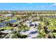 Scenic community entrance showcasing lush landscaping with palm trees, a pond, and a modern entrance gatehouse at 5740 Eagle Creek Rd, Sarasota, FL 34238