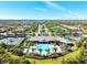 Aerial view of a community pool, clubhouse, and well manicured grounds in a residential area at 5740 Eagle Creek Rd, Sarasota, FL 34238