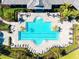 Aerial shot showcases a large community pool, spa, and patio area with ample lounge seating at 5740 Eagle Creek Rd, Sarasota, FL 34238