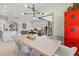 Dining room features modern light fixture, art and a sliding glass door to the patio at 5740 Eagle Creek Rd, Sarasota, FL 34238