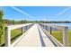 A long dock with wooden railings, offering stunning views of the lake and surrounding greenery at 5740 Eagle Creek Rd, Sarasota, FL 34238