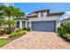 Charming single-Gathering home with a well-manicured lawn, tropical landscaping, and a two-car garage at 5740 Eagle Creek Rd, Sarasota, FL 34238