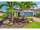 Beautiful home with well-manicured landscaping, palm trees, and a paver driveway leading to the garage at 5740 Eagle Creek Rd, Sarasota, FL 34238
