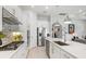 Bright white kitchen features quartz countertops, island, and stainless appliances at 5740 Eagle Creek Rd, Sarasota, FL 34238
