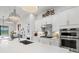 Bright, white kitchen features stainless appliances and quartz countertops at 5740 Eagle Creek Rd, Sarasota, FL 34238