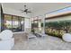 Inviting screened lanai featuring brick flooring and comfortable lounge seating with a picturesque view at 5740 Eagle Creek Rd, Sarasota, FL 34238