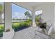 Relaxing screened lanai offering serene lake views and comfortable seating amid lush landscaping at 5740 Eagle Creek Rd, Sarasota, FL 34238