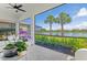 The tiled lanai offers a peaceful retreat with water views and comfortable seating near tropical foliage at 5740 Eagle Creek Rd, Sarasota, FL 34238