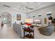 Living room featuring neutral walls, decor, ceiling fan, and adjacent entry hall at 5740 Eagle Creek Rd, Sarasota, FL 34238