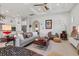 Bright living room features modern decor, unique art, and a coffered ceiling with fan at 5740 Eagle Creek Rd, Sarasota, FL 34238