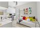 Bright office area with desk, cabinets, daybed with colorful pillows, and stylish decor at 5740 Eagle Creek Rd, Sarasota, FL 34238