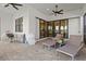 Well-designed outdoor patio with lounge seating and ceiling fan, overlooking the landscape at 5740 Eagle Creek Rd, Sarasota, FL 34238