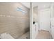 Modern bathroom with a large walk-in shower featuring neutral tile and a small window at 5740 Eagle Creek Rd, Sarasota, FL 34238