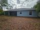 View of the back exterior of the house, featuring a screened in back porch in a large back yard at 5849 Wagon Wheel Dr, North Port, FL 34291