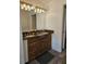 Bathroom featuring double sinks, granite countertops, and dark wood cabinets at 5849 Wagon Wheel Dr, North Port, FL 34291