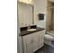 Bathroom features a granite topped vanity, framed mirror, and tub with tile surround at 5849 Wagon Wheel Dr, North Port, FL 34291