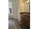 Bathroom features a single sink vanity, a soaking tub and hardwood floors at 5849 Wagon Wheel Dr, North Port, FL 34291
