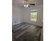 Bedroom features wood-look floors, ceiling fan and window looking out to the backyard at 5849 Wagon Wheel Dr, North Port, FL 34291