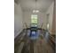 Bright dining room features wood floors, a modern chandelier and views of the backyard at 5849 Wagon Wheel Dr, North Port, FL 34291
