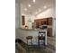 Bright kitchen with light wood cabinets, bar seating, and stainless steel appliances at 5849 Wagon Wheel Dr, North Port, FL 34291
