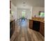 Open kitchen and dining area features granite counters, wood cabinets, and stainless dishwasher at 5849 Wagon Wheel Dr, North Port, FL 34291