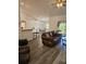Open-concept living room and dining area with hardwood floors and a leather sofa at 5849 Wagon Wheel Dr, North Port, FL 34291