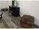 Living room featuring a black TV stand and ottoman with wood-look floors at 5849 Wagon Wheel Dr, North Port, FL 34291