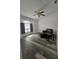 Cozy living area featuring durable hardwood floors, a ceiling fan, and a large window providing natural light at 5849 Wagon Wheel Dr, North Port, FL 34291