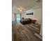 Spacious primary bedroom boasts hardwood floors, a ceiling fan, and a glass sliding door that leads to the backyard at 5849 Wagon Wheel Dr, North Port, FL 34291