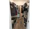 Walk-in closet featuring shelving and hardwood floors for organized storage at 5849 Wagon Wheel Dr, North Port, FL 34291