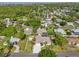 Aerial shot showcasing the property and its surrounding neighborhood with mature trees at 5988 Viola Rd, Venice, FL 34293