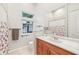 Well-lit bathroom showcasing a wooden vanity, neutral walls, and a large mirror, creating a clean and functional space at 5988 Viola Rd, Venice, FL 34293