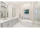 Elegant bathroom featuring double sinks, a soaking tub, and neutral colors at 5988 Viola Rd, Venice, FL 34293