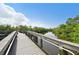 View of a wooden boardwalk through a lush mangrove forest; blue skies above at 5988 Viola Rd, Venice, FL 34293