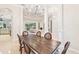 Elegant dining room with large table and an open floorplan to living area at 5988 Viola Rd, Venice, FL 34293